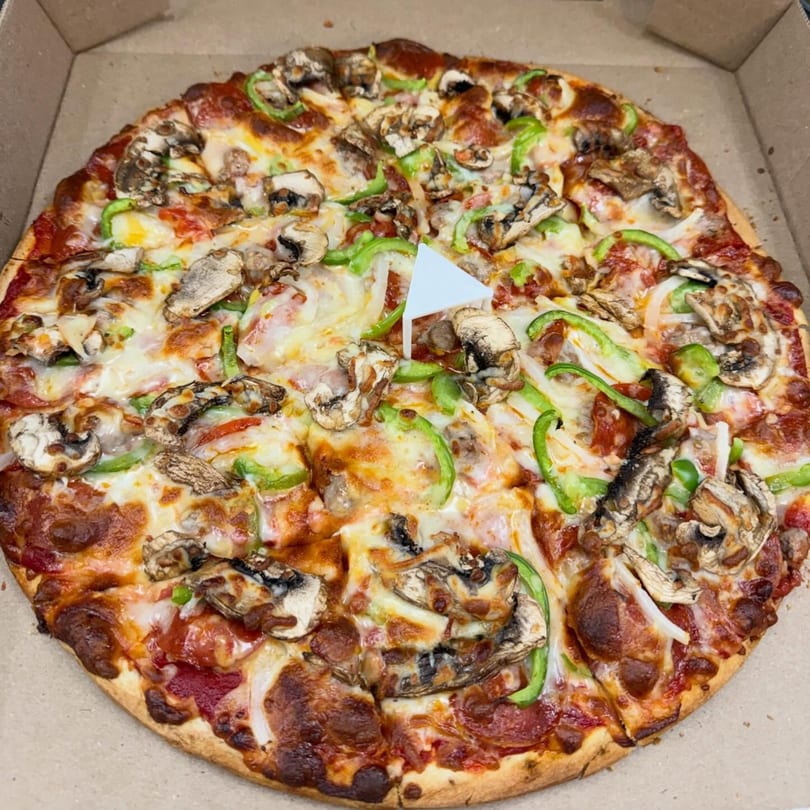 Hampton Hill Pizza's pepperoni, mushroom, and green pepper pizza in a cardboard box.